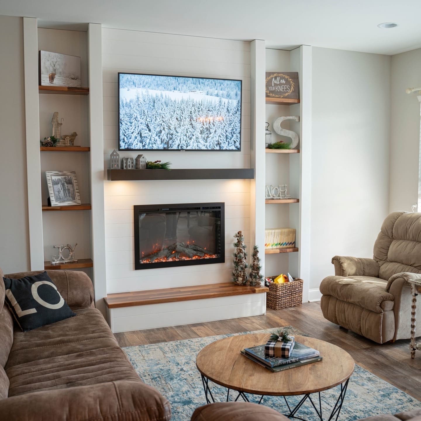 electric fireplace with glass door, white tile surround and dark wood mantel in a living room